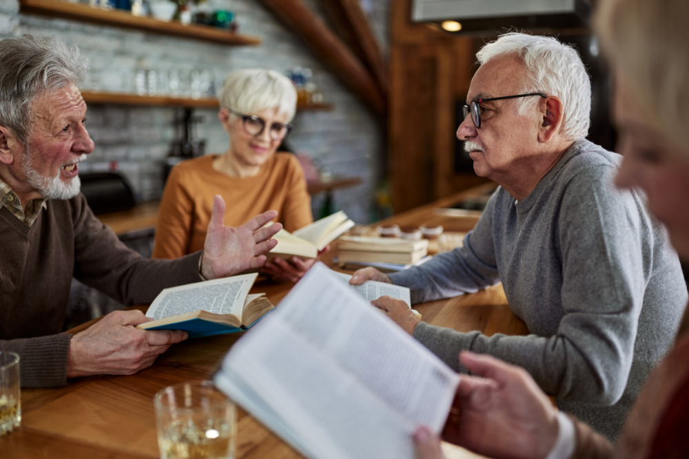 men and woman sitting at table discussing